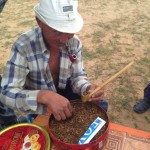 Our host preparing a pipe with tobacco.