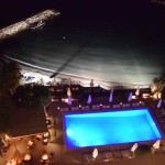 View of pool and beach at night