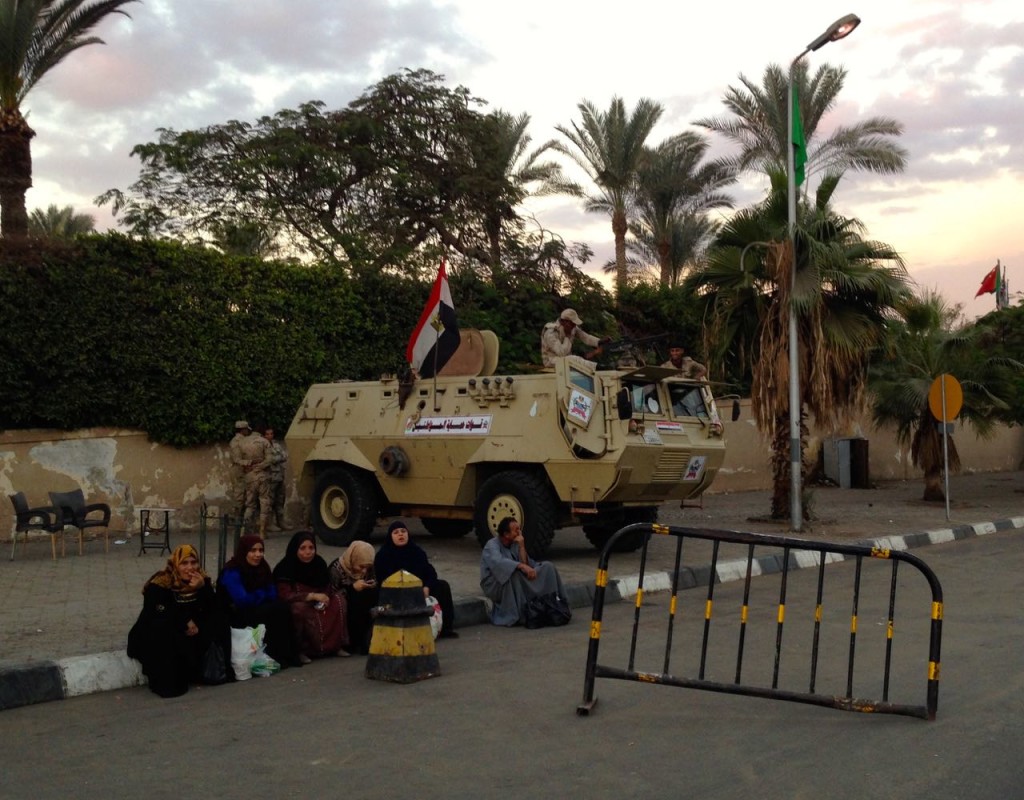Military security with an armored vehicle outside of the Pyramids.